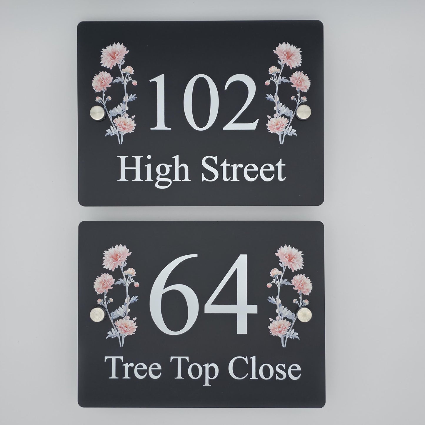 Modern acrylic house number plaque featuring a beautiful floral design, mounted with standoff fixings on a house wall