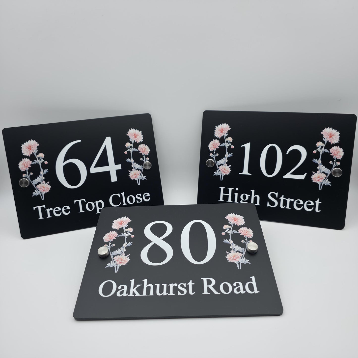 Custom-made acrylic house number plaque with an elegant floral print for a contemporary home exterior