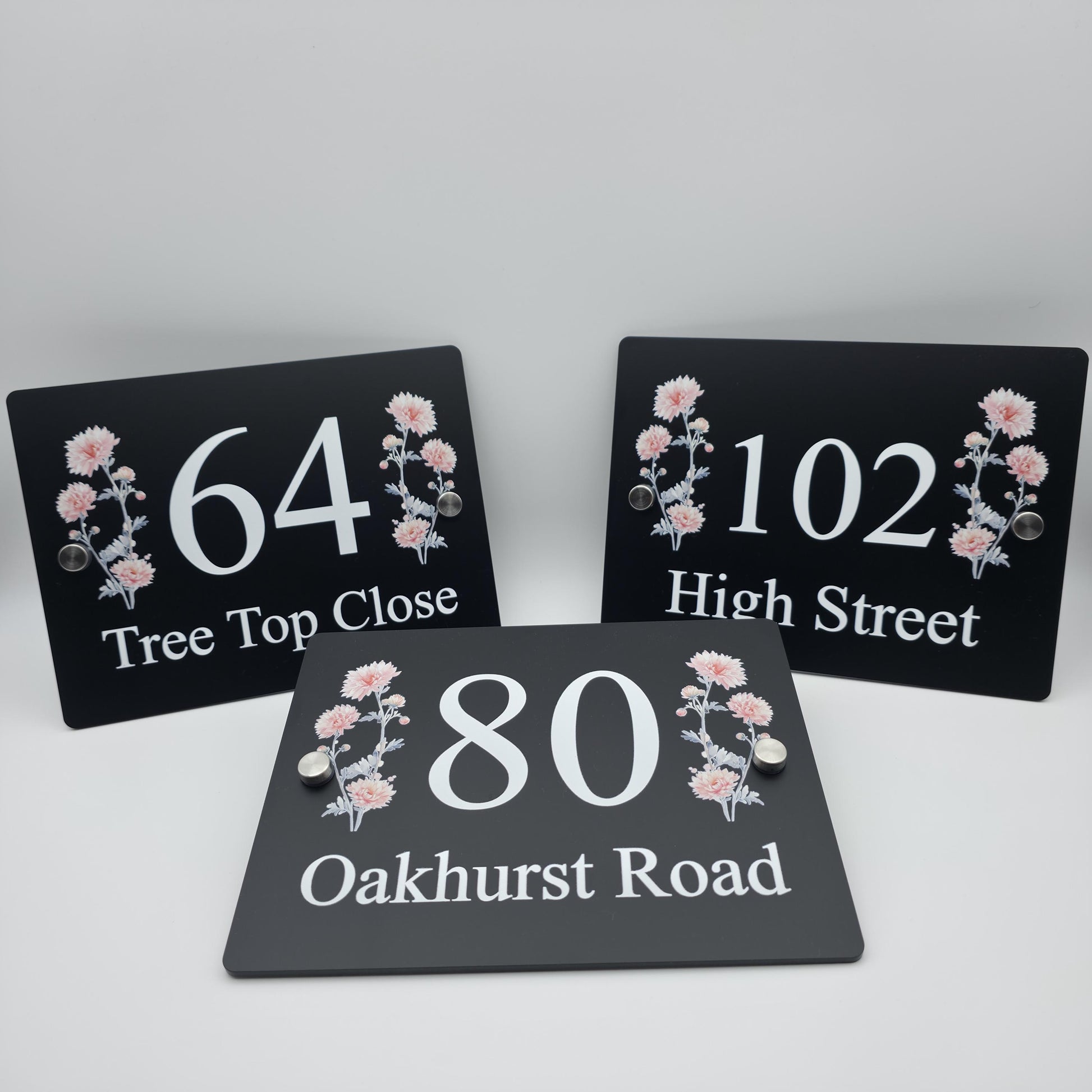 Custom-made acrylic house number plaque with an elegant floral print for a contemporary home exterior